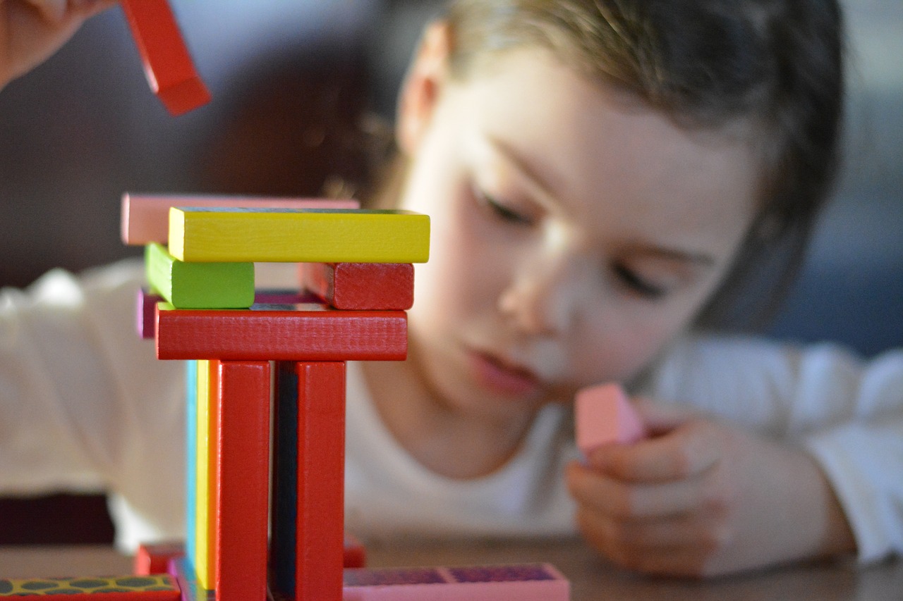 Child building skills through play during one-on-one ABA therapy